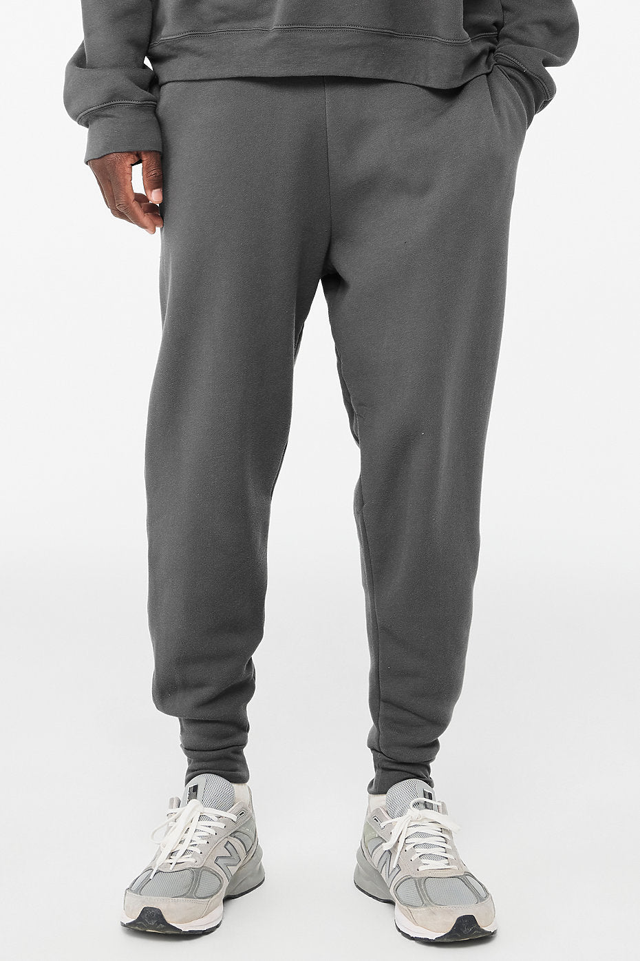 Unisex sponge fleece jogger sweatpants in dark gray with side pockets and ribbed ankle cuffs