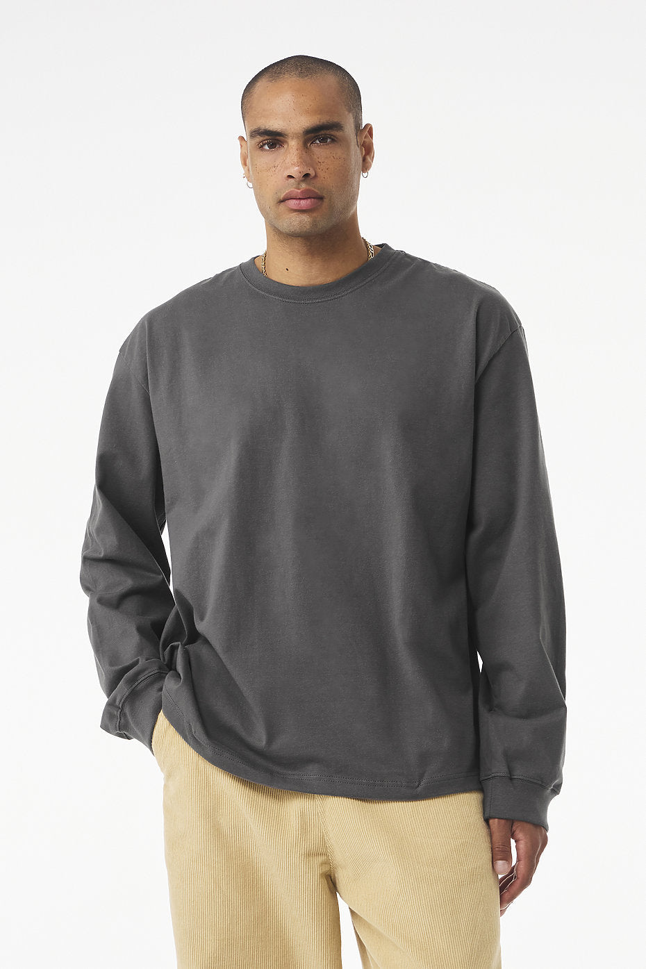 Unisex heavyweight long sleeve tee in charcoal gray with relaxed fit and ribbed cuffs worn by male model