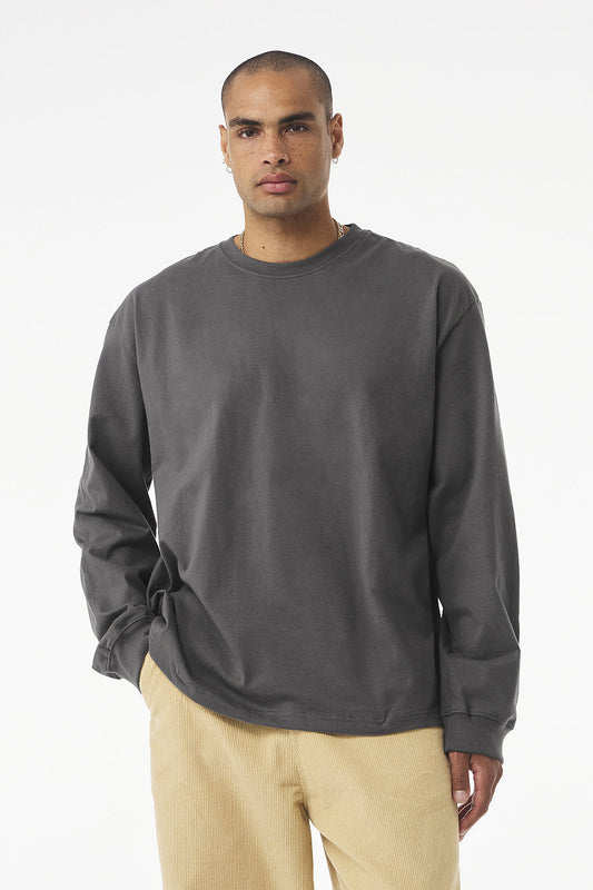 Unisex heavyweight long sleeve tee in charcoal gray with relaxed fit and ribbed cuffs worn by male model